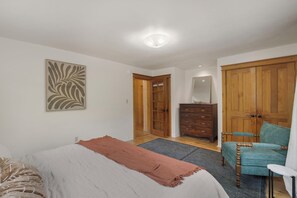 A bedroom with a bed, a dresser, a chair, and a wardrobe. - Entire Home-Charming Historic Adobe Prime Location (Santa Fe)
