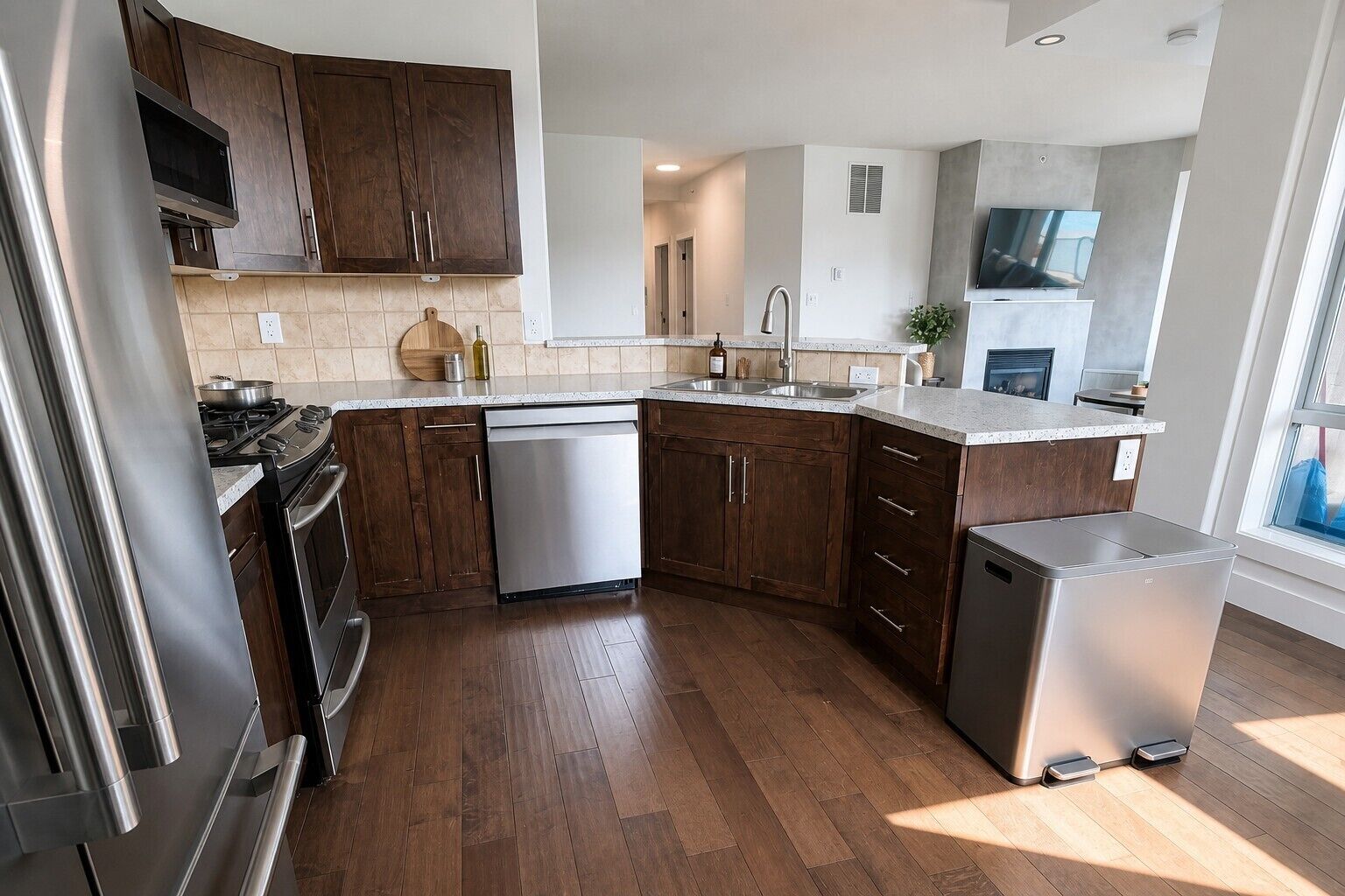 A modern kitchen with wooden cabinets, stainless steel appliances, and a dishwasher.