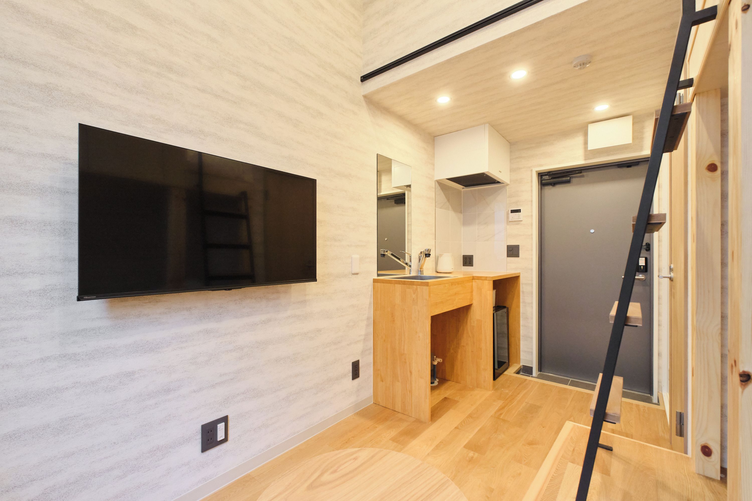 A modern bathroom with a wooden vanity, a built-in sink, and a mirror.