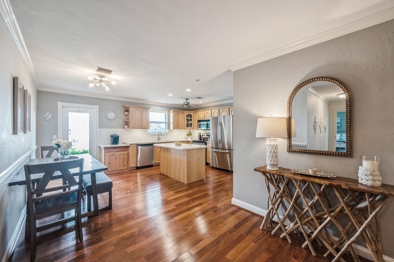 A spacious kitchen with wooden cabinets, a central island, and stainless steel appliances.