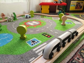 A toy train set on a circular track with various figures and symbols.