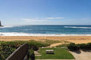 A beach view with a grassy area and a bench. - Kosynook - On the Beach (Mona Vale)