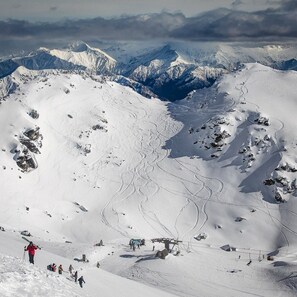 A snow-covered mountain with ski trails and a ski lift.