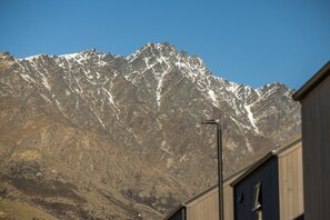 A mountain range with snow-capped peaks and a clear sky.