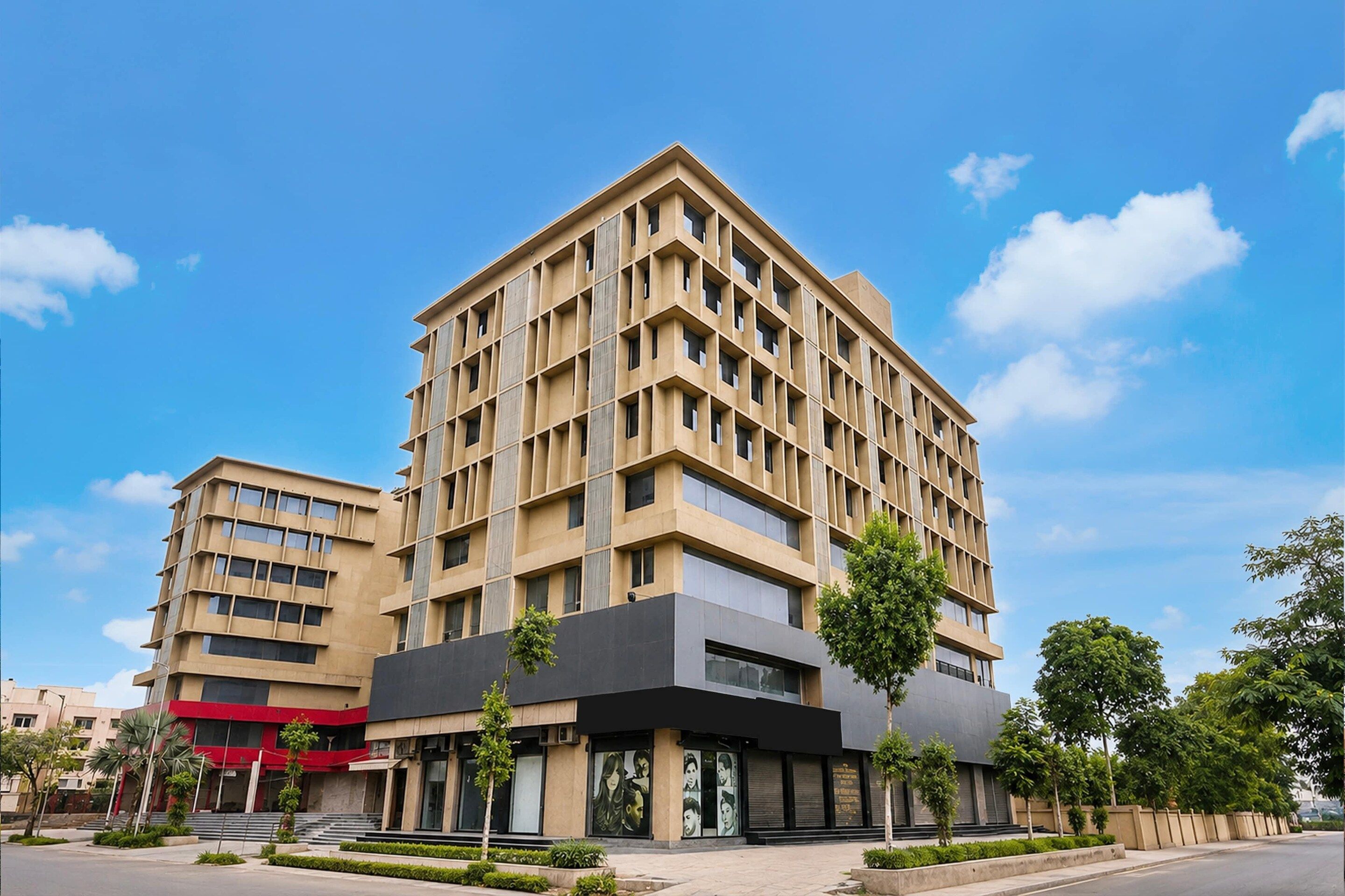 A multi-story building with a modern architectural style, featuring a mix of rectangular and square windows.