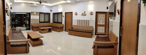 A modern interior with a seating area, a reception desk, and decorative wall art.