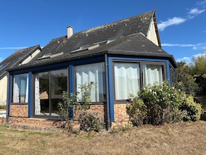A house with a sloped roof, large windows, and a brick exterior. - Relaxing Holiday Home in Normandy (Courtils)