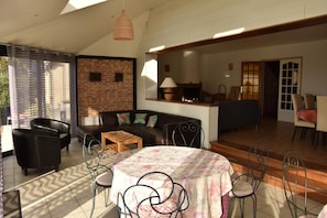 A living room with a sofa, chairs, a coffee table, and a fireplace. - Relaxing Holiday Home in Normandy (Courtils)