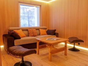 A cozy room with a sofa, a wooden coffee table, and a bench. - Apartment Armina by Interhome (Zermatt)