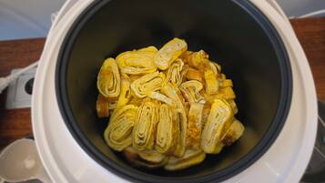 An air fryer containing sliced pastries.