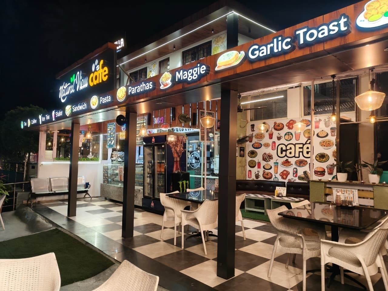 An outdoor café with a checkered floor, tables, and chairs.