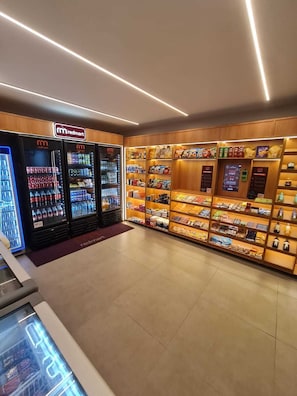 A Redmart store with refrigerated beverage dispensers and shelves stocked with snacks and beverages. - Carneiros Beira-Mar | 2Q | Nomar Ecoliving (Tamandare)