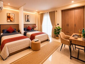 A hotel room with two beds, a desk, a chair, a potted plant, and a large wardrobe. - C Suites Maclean (Bengaluru)