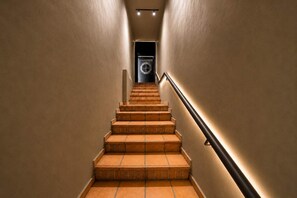 A staircase with a handrail and a door at the top. - Central Bella Vista Apt w/ Terrace & Fast WiFi (Panama City)