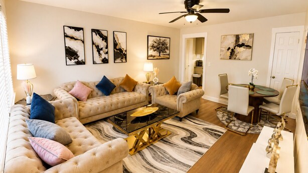 A living room with two sofas, a coffee table, and a dining area with chairs and a table. - Luxury Modern Apartment weekly discount & monthly (Cullman)