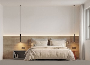 Un dormitorio moderno con cabecera de madera, cama con edredón blanco y lámparas colgantes.