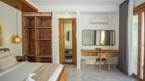 A bedroom with a wooden wardrobe, a bed with a white headboard, a desk with a chair, and a large mirror. - Ubud 2BR Villa Private Pool Abhimanyu (Ubud)