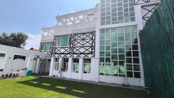 A two-story building with a white facade and black geometric patterns.