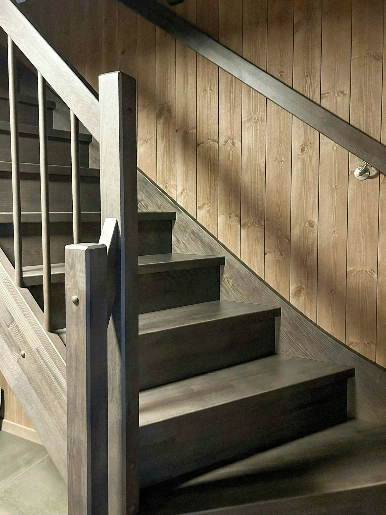 A staircase with wooden steps and metal railings.