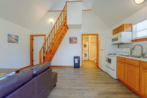 A spacious kitchen with wooden cabinets, a built-in oven, and a microwave.