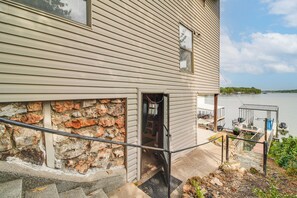 A house with a stone foundation, a wooden exterior, and a dock extending into a body of water. - Bring Your Boat! Grand Lake Escape w/ Dock (Grove)