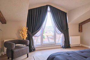 A room with a large window, a chair, a radiator, and a view of the outside. - Carlsen, GOAT, Unique, Full City View Terrace (Kadıköy)