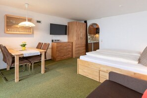 A compact room with a bed, a desk, a chair, a wardrobe, and a television. - Top 9 for 2-3 people / 1st floor (Schröcken)