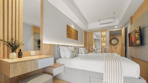 A modern bedroom with a large bed, bedside tables, a mirror, and a TV. - Galia by Kozystay - Nusa Dua (South Kuta)
