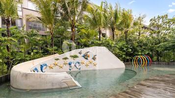 A swimming pool with a curved edge and a mural of sea creatures.