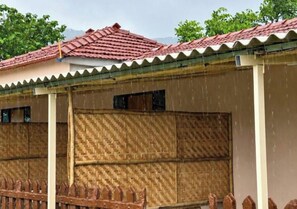 A building with a tiled roof and a woven wall.