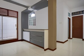A hallway with a tiled floor, a door with a window, and a wall-mounted light fixture. - Luxury Deluxe DBL Retreat W/ Free WiFi and Parking (Medan)