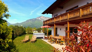 A chalet with a patio, outdoor seating, and a hot tub. - Vrbo Property (Unterwössen)