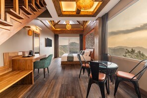 A modern hotel room with a wooden staircase, a bed, a desk, and a dining area. - Saanjh The Musical Sunset | RUA Cafe & Lounge (Shimla)