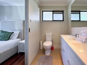 A hotel room with a bed, a toilet, a sink, and a window. - Waterfront Retreat with Pool & Pontoon, Broadbeach (Broadbeach Waters)