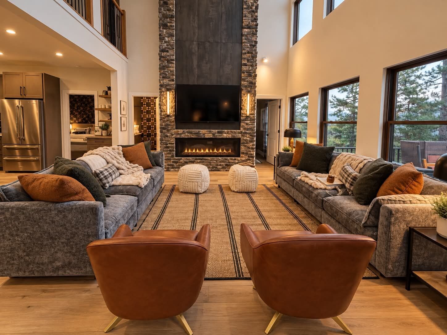 A modern living room with a fireplace, two sofas, and a television.