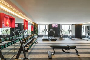A gym with treadmills, dumbbells, and exercise equipment. - The Mulian Hotel (ChengDu)
