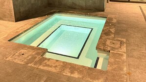 A modern indoor pool with a rectangular shape and a tiled border. - The Eastbourne Premium 2BR Central Canberra (Parkes)