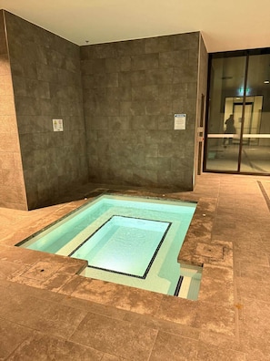 A modern indoor pool with a rectangular shape and a tiled border. - The Eastbourne Premium 2BR Central Canberra (Parkes)