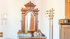 A room with a wooden-framed mirror, a vintage radio, and a wall-mounted telephone. - No. 9 - Spacious 140 m² Apartment in Mestre (Mestre)