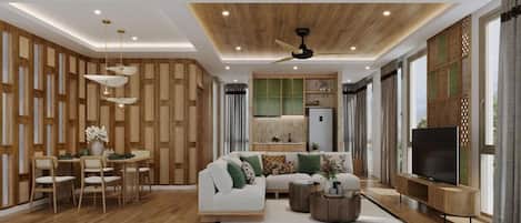 A modern living room with a sofa, coffee table, and TV. There is a dining area with chairs and a table. The room has wooden paneling on the walls and a ceiling fan.