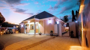 A two-story building with a paved driveway and a gated entrance.