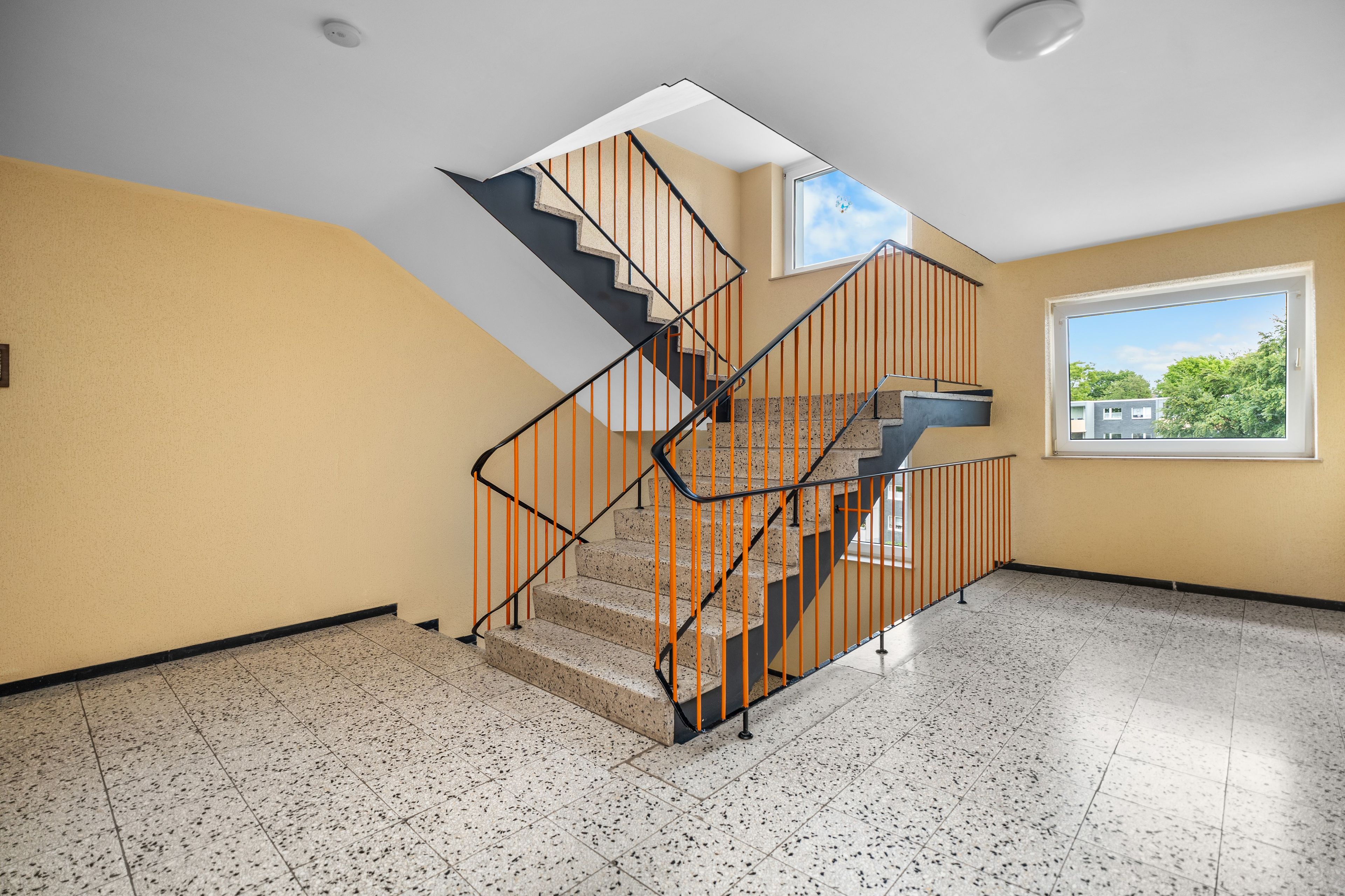 Un escalier au design moderne, menant à l’étage supérieur.