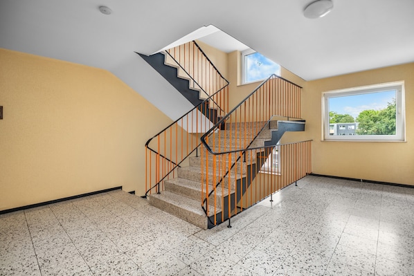 A staircase with a modern design, leading to an upper floor.