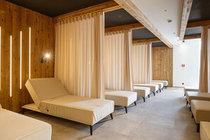 A room with multiple beds arranged in a row, wooden paneling on the walls, and a ceiling with exposed beams. - Ofs_e_superior Mh_2sz_m.b._fis_7 (Fiss)