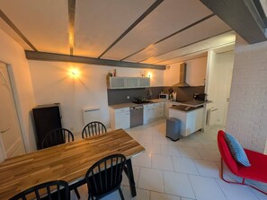 A compact kitchen with white cabinets, a microwave, and a sink. - La Fabrique - Downtown Loft (Nancy)
