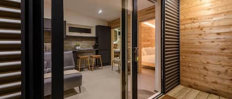 A modern interior with a sliding glass door leading to a kitchen and living area.