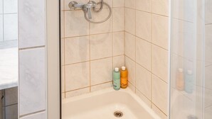 A walk-in shower with a glass door, a handheld showerhead, and a handheld shower attachment. - Comfortable Family Apartment With 3 Bedrooms (Antwerp)