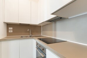 A modern kitchen with white cabinetry, a stainless steel sink, and a black induction cooktop. - A comfortable 65 sqm flat that sleeps up to 4 people, located on the 4th floor of a building with an elevator (though there are stairs to reach the entrance).The property is situated in the Piazza Cinque Giornate-Corso XXII Marzo area, a well served resi (Milan)