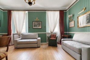 A room with two sofas, a chair, a small table, and a chandelier. - A comfortable 65 sqm flat that sleeps up to 4 people, located on the 4th floor of a building with an elevator (though there are stairs to reach the entrance).The property is situated in the Piazza Cinque Giornate-Corso XXII Marzo area, a well served resi (Milan)