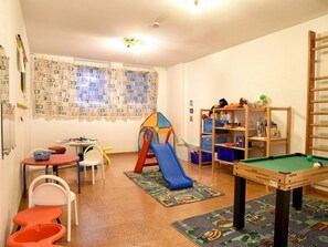A children's playroom with a pool table, play area, and storage shelves. - Holiday Apartment With 1 Bedroom (Wyk auf Foehr)